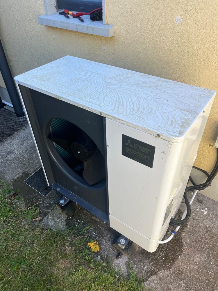 Outdoor heat pump unit sited with clear space around it
